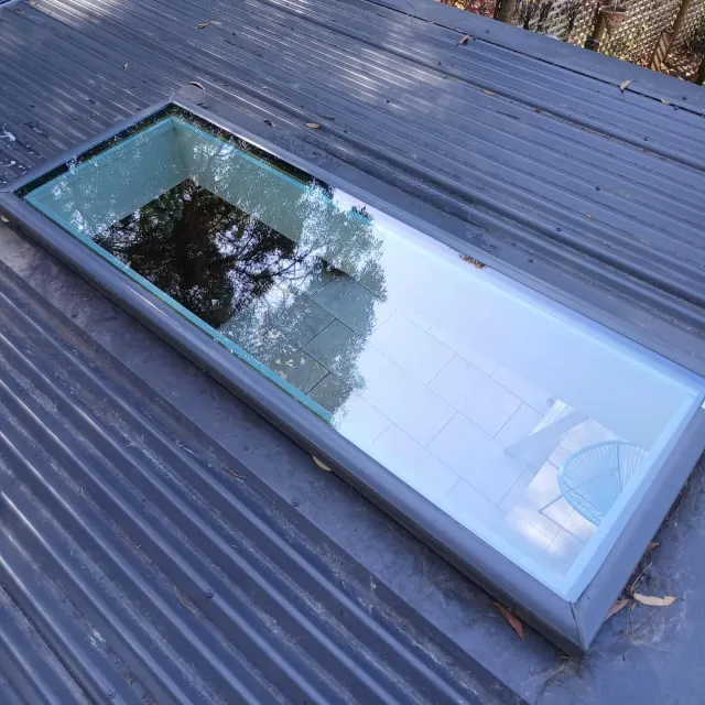 Clean skylight on a grey tin roof