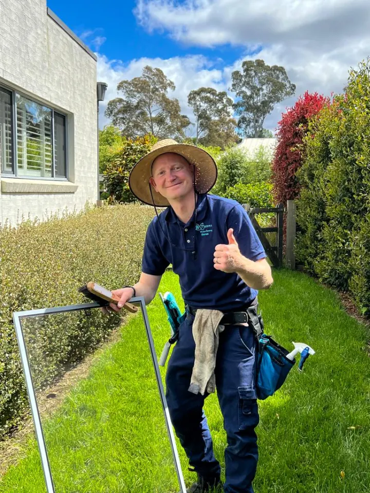 Shannan from Sierra Window Cleaning holding a freshly cleaned fly screen