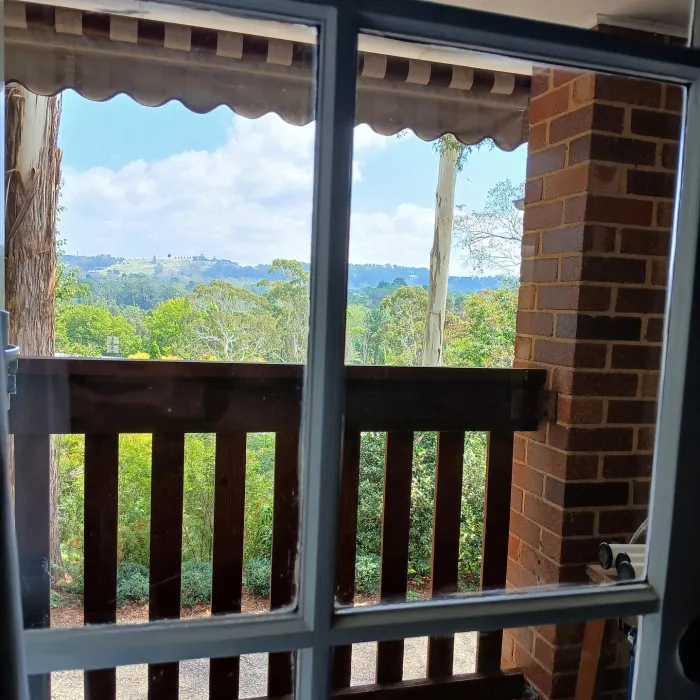 Clean balcony windows framing a Highlands valley view